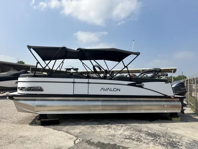 Slide: The Image of 2024 Avalon Catalina 25' Quad Lounger pontoon boat with black canopy. - 3