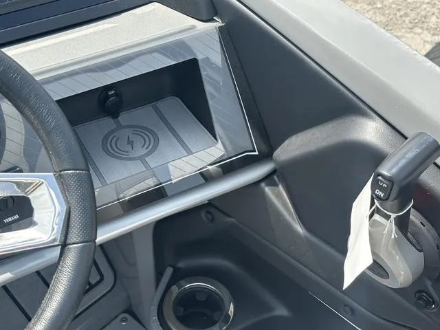 Slide: The Image of 2024 Avalon Catalina 25' Quad Lounger dashboard with wireless charging pad and controls. - 30