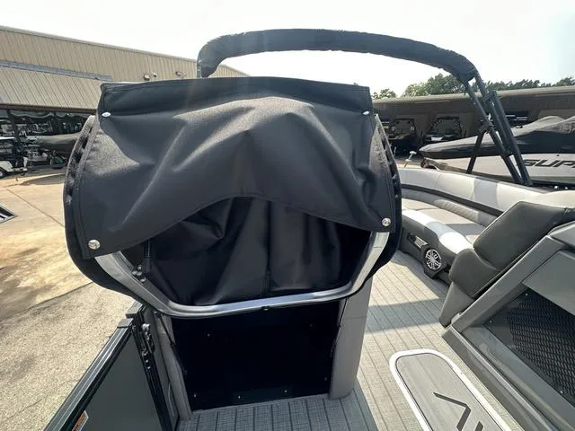 Slide: The Image of 2024 Avalon Catalina 25' Quad Lounger boat interior with covered helm station. - 34