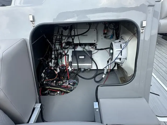 Slide: The Image of Electrical compartment of 2024 Avalon Catalina 25' Quad Lounger boat with wiring and components. - 40