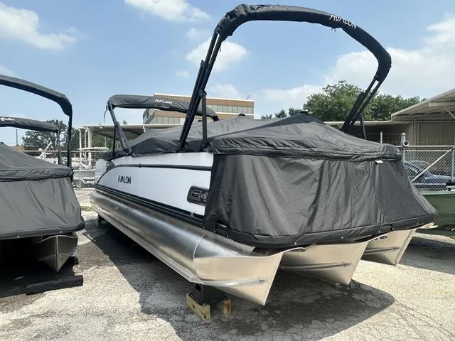 Slide: The Image of 2024 Avalon Catalina 25' Quad Lounger pontoon boat, covered and docked. - 5