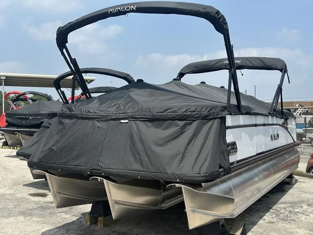 Slide: The Image of 2024 Avalon Catalina 25' Quad Lounger pontoon boat with black cover. - 7