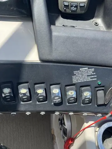 Slide: The Image of Control panel of a 2015 Bennington 25 IO QCW boat with various switches. - 12