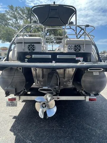 Slide: The Image of 2015 Bennington 25 IO QCW pontoon boat rear view with propeller and speakers. - 2