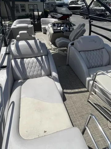 Slide: The Image of 2015 Bennington 25 IO QCW pontoon boat with luxurious seating and modern dashboard. - 4