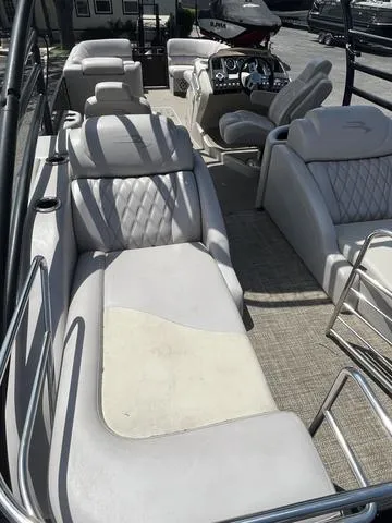 Slide: The Image of 2015 Bennington 25 IO QCW boat interior with luxurious seating and modern dashboard. - 5