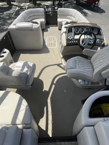 Slide: The Image of 2015 Bennington 25 IO QCW boat interior with luxurious seating and modern dashboard. - 6