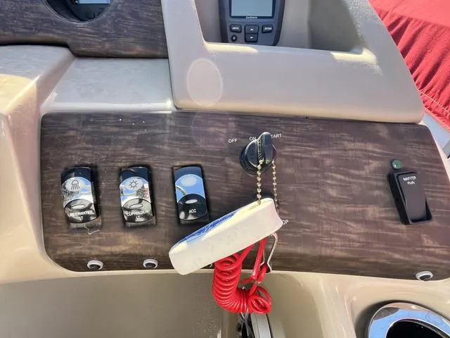 Slide: The Image of 2015 Bennington 2275 RCW boat dashboard with ignition, switches, and safety lanyard. - 10