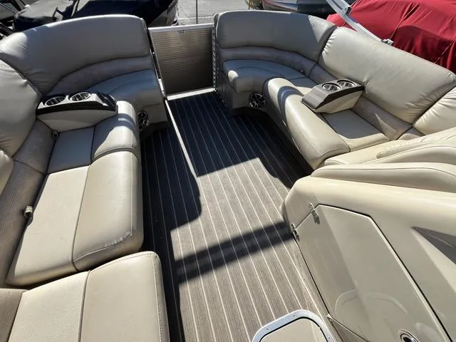 Slide: The Image of 2015 Bennington 2275 RCW boat interior with beige leather seating and striped flooring. - 13