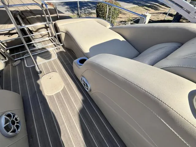 Slide: The Image of 2015 Bennington 2275 RCW boat interior with beige seating and wood-like flooring. - 4