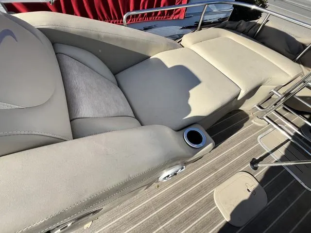 Slide: The Image of 2015 Bennington 2275 RCW boat interior with beige seating and cup holder. - 5