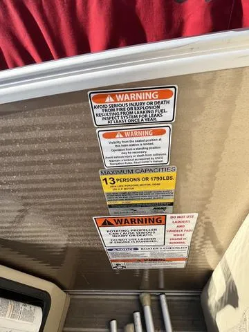 Slide: The Image of Warning labels on a 2015 Bennington 2275 RCW boat, indicating maximum capacity. - 7