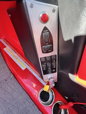 Slide: The Image of 2016 MasterCraft X30 boat control panel with switches and ignition key. - 14