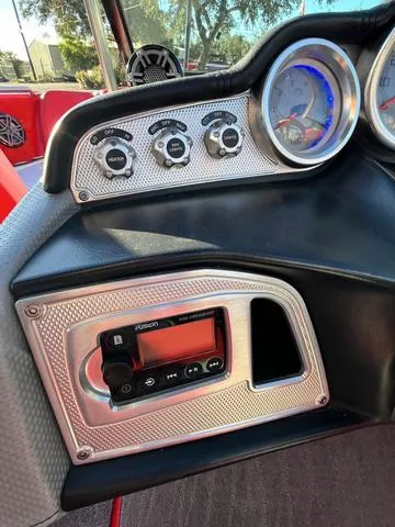Slide: The Image of 2016 MasterCraft X30 boat dashboard with control panel and gauges. - 16