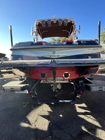 Slide: The Image of 2016 MasterCraft X30 boat rear view with trailer on a sunny day. - 22