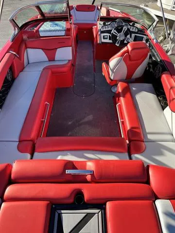 Slide: The Image of 2016 MasterCraft X30 boat with red and white interior seating. - 8