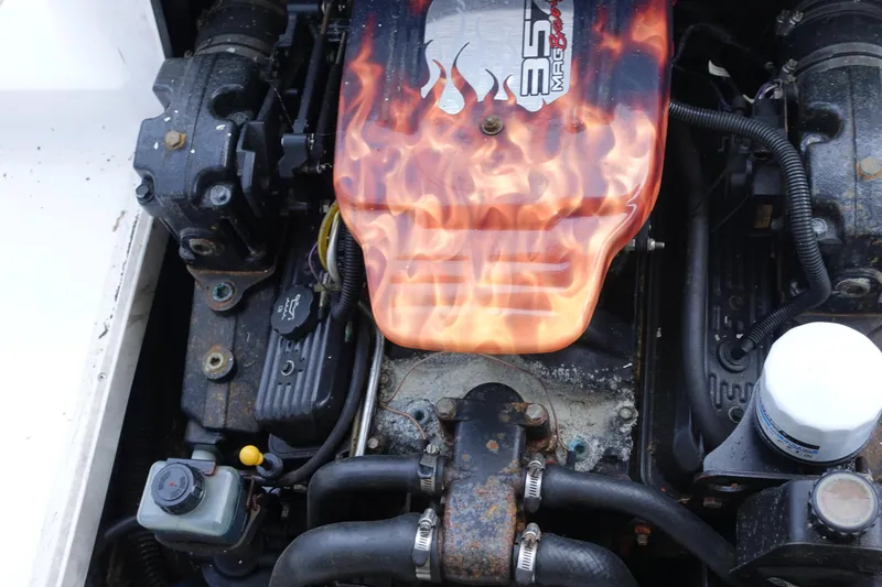 Slide: The Image of Engine of a 2000 Pro-Line 24 Walk boat with flame design cover. - 11