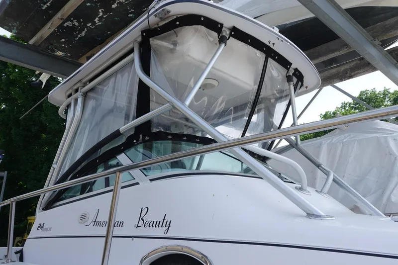 Slide: The Image of 2000 Pro-Line 24 Walk boat named "American Beauty" with protective canopy. - 4