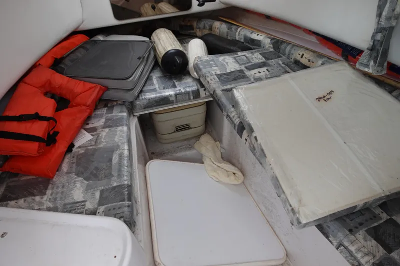 Slide: The Image of Interior of 2000 Pro-Line 24 Walk boat with life jackets and storage compartments. - 7