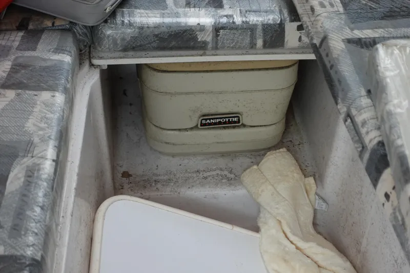 Slide: The Image of Portable toilet in a 2000 Pro-Line 24 Walk boat storage compartment. - 8