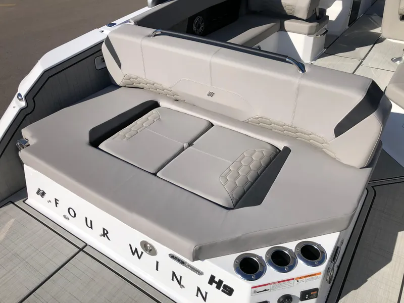 Slide: The Image of 2025 Four Winns H9 boat with luxurious seating and cup holders. - 11