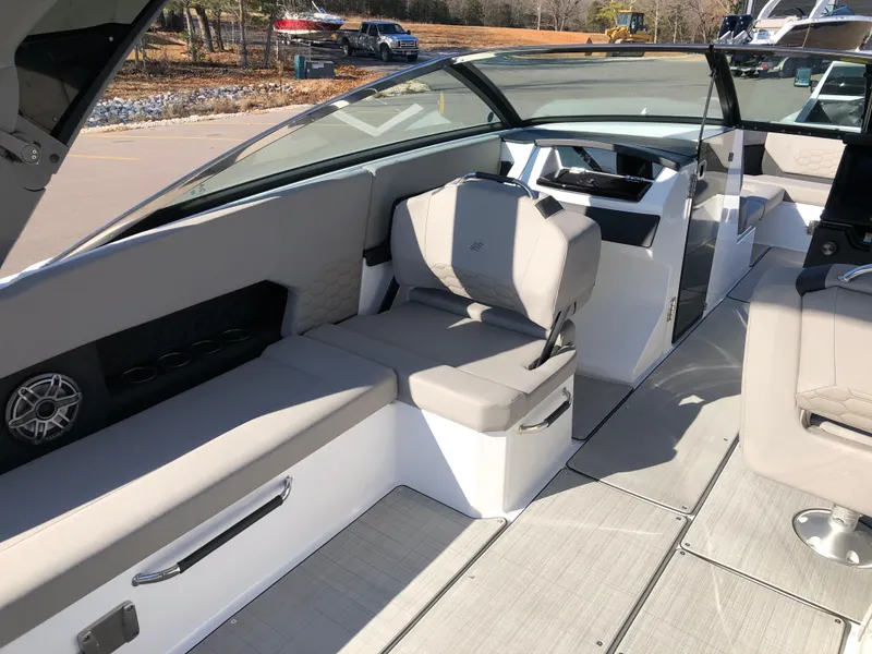 Slide: The Image of 2025 Four Winns H9 boat interior with modern seating and sleek design. - 14