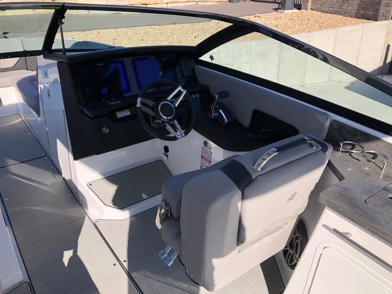 Slide: The Image of 2025 Four Winns H9 boat cockpit with modern steering and controls. - 15