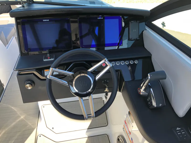 Slide: The Image of 2025 Four Winns H9 boat dashboard with dual screens and modern steering wheel. - 16