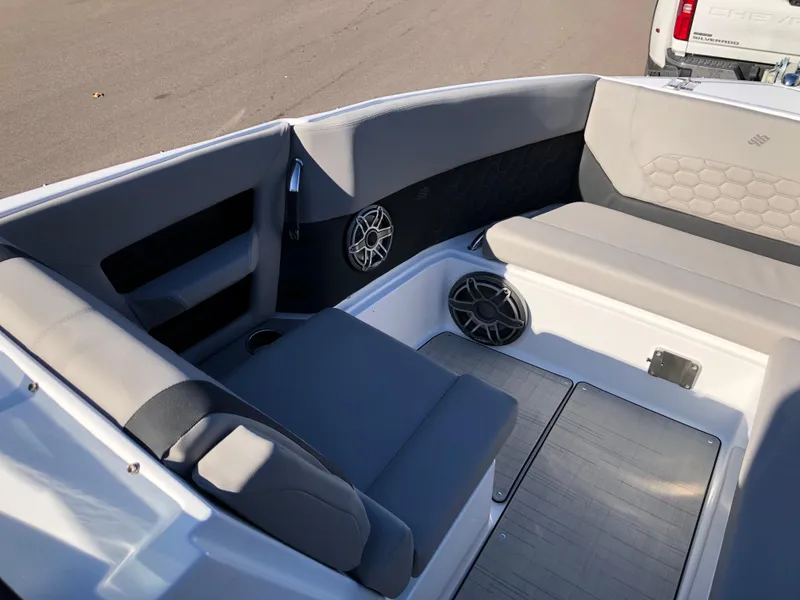 Slide: The Image of 2025 Four Winns H9 boat interior with gray seating and speakers. - 20