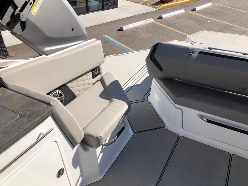 Slide: The Image of 2025 Four Winns H9 boat interior with modern seating and sleek design. - 23