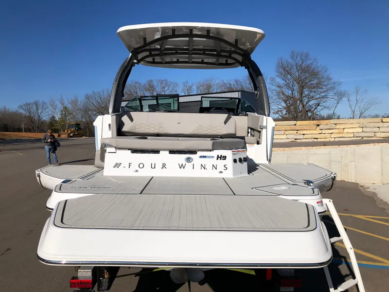 Slide: The Image of 2025 Four Winns H9 boat, rear view, on a sunny day. - 26