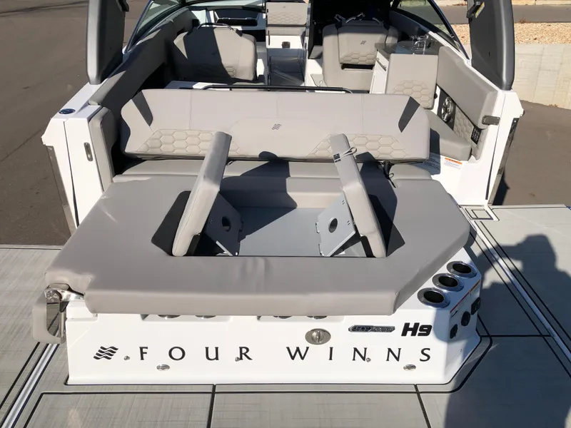 Slide: The Image of 2025 Four Winns H9 boat interior with seating and cup holders. - 29