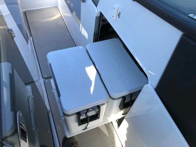 Slide: The Image of 2025 Four Winns H9 boat interior with storage compartments and coolers. - 30