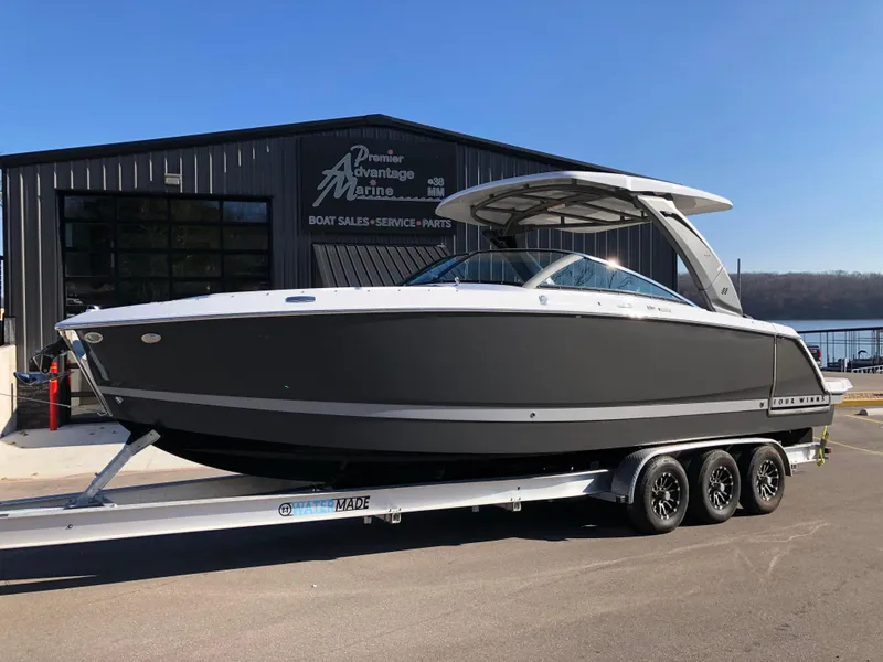 The Image of 2025 Four Winns H9 boat on trailer outside marine dealership. - 5
