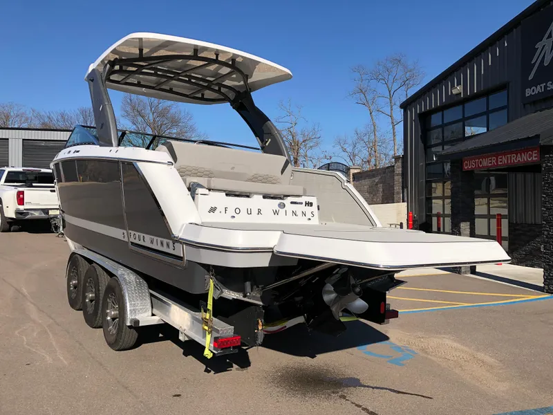 Slide: The Image of 2025 Four Winns H9 boat on trailer outside dealership. - 8