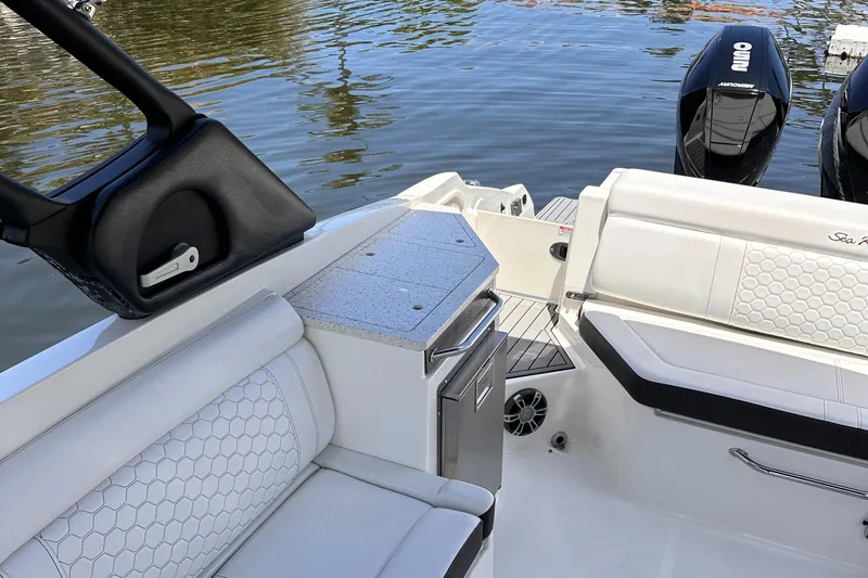 Slide: The Image of 2021 Sea Ray SDX 290 Outboard boat interior with seating and storage. - 10