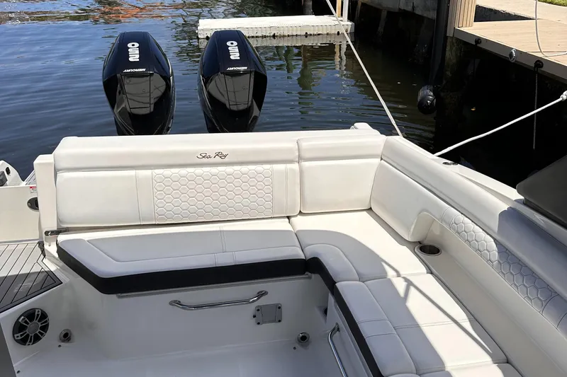 Slide: The Image of 2021 Sea Ray SDX 290 Outboard boat with white leather seating and twin outboard engines. - 11