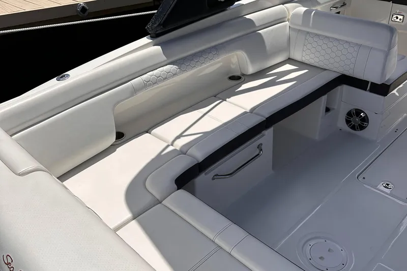 Slide: The Image of 2021 Sea Ray SDX 290 Outboard boat interior with white cushioned seating. - 12
