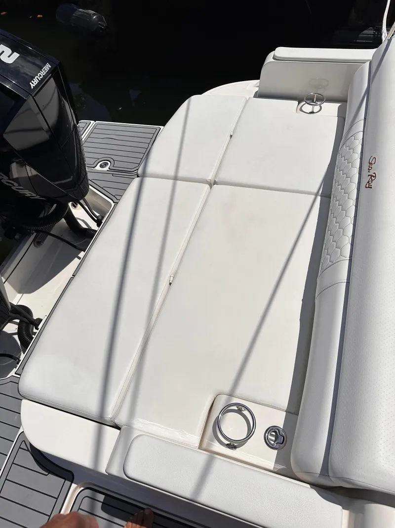 Slide: The Image of 2021 Sea Ray SDX 290 Outboard boat with white seating and outboard motor. - 15