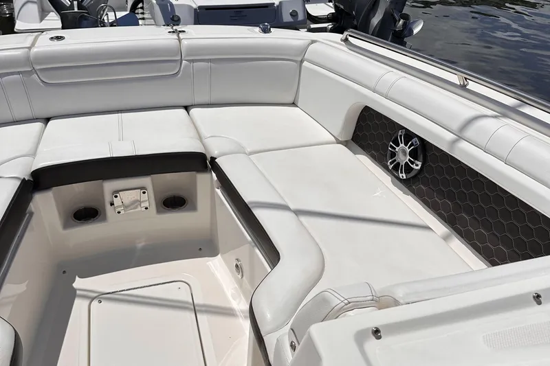 Slide: The Image of 2021 Sea Ray SDX 290 Outboard boat interior with white cushioned seating. - 4