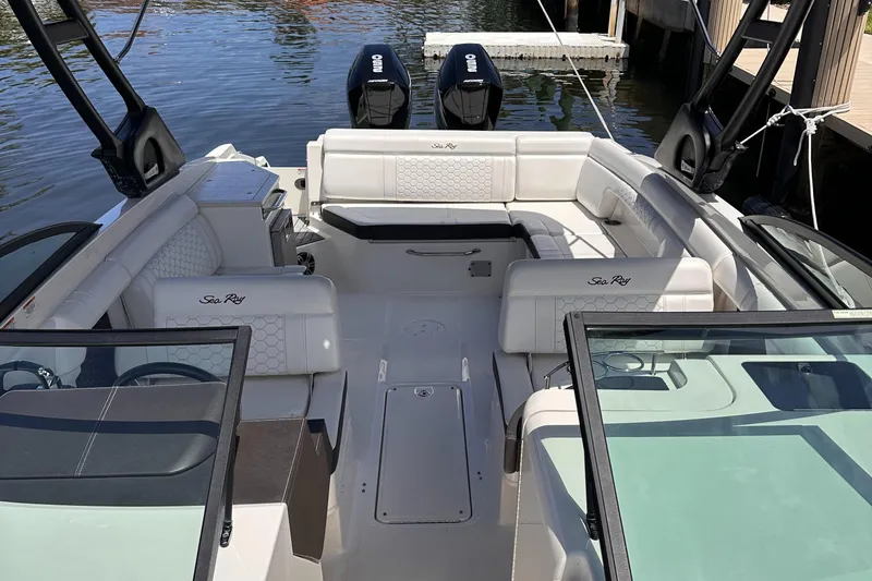 Slide: The Image of 2021 Sea Ray SDX 290 Outboard boat interior with white seating and dual engines. - 6
