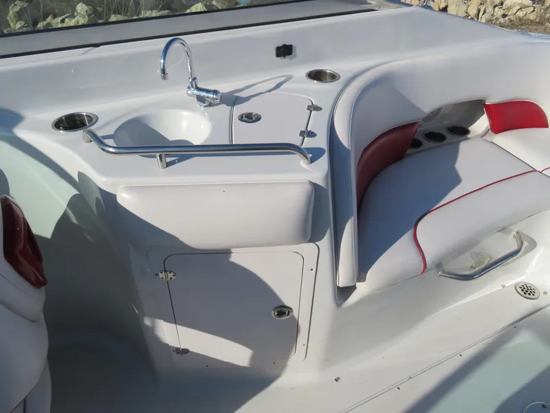 Slide: The Image of Crownline 275 SS 2012 boat interior with sink and seating area. - 12
