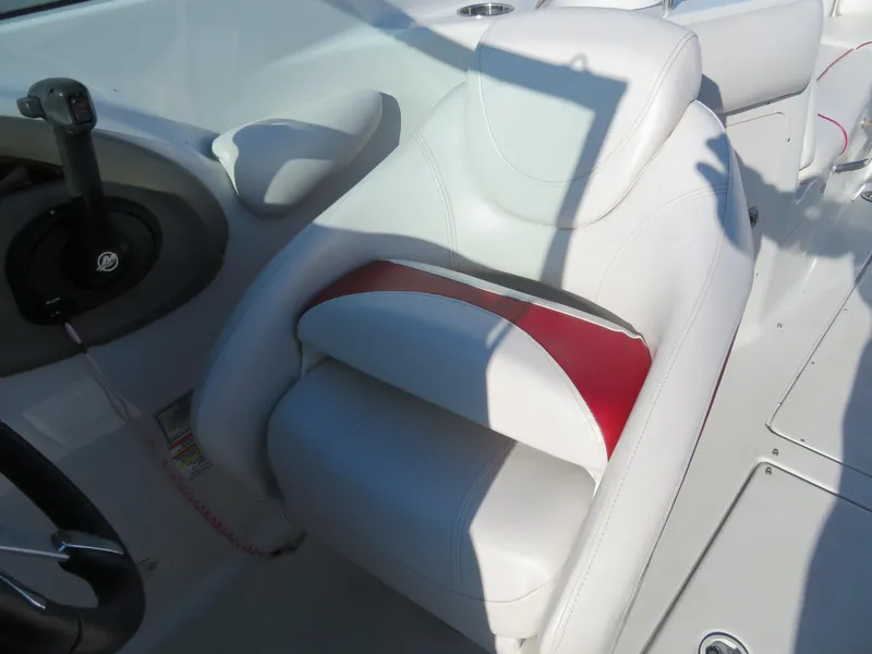 Slide: The Image of Captain's seat of a 2012 Crownline 275 SS boat with white and red upholstery. - 16