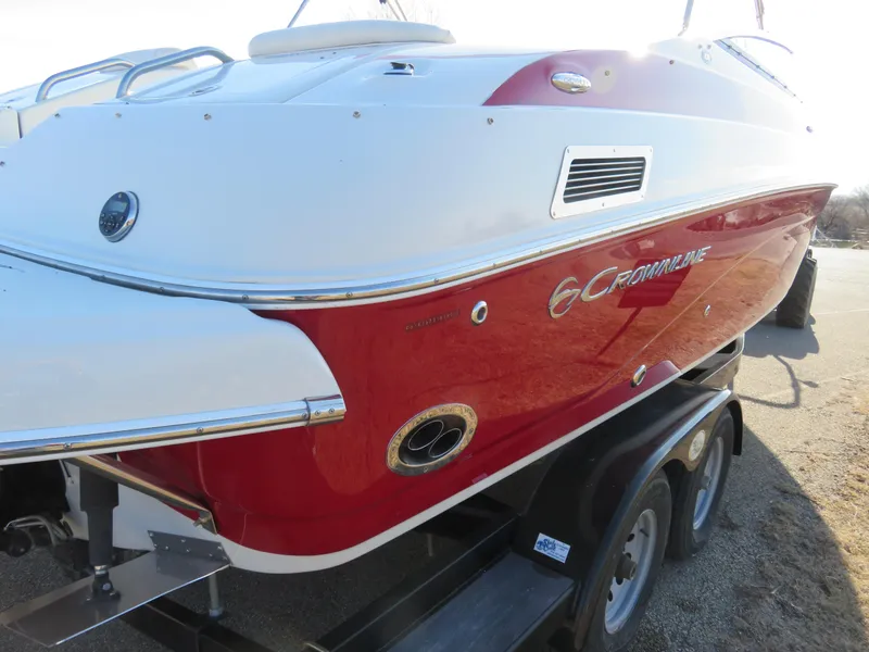 Slide: The Image of 2012 Crownline 275 SS boat on trailer, red and white exterior. - 6