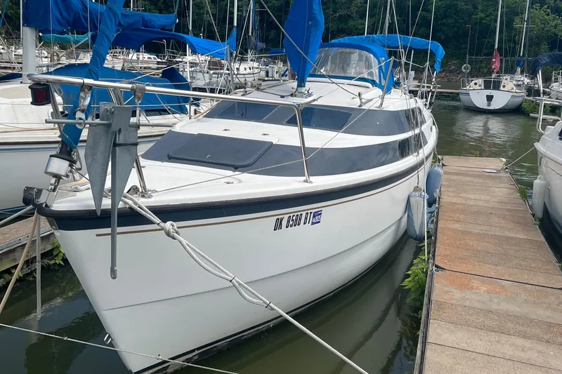 The Image of 2010 MacGregor 26M sailboat docked at a marina. - 0