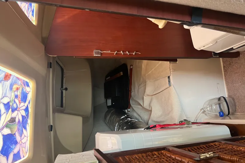 Slide: The Image of Interior cabin of a 2010 MacGregor 26M sailboat with stained glass windows. - 11