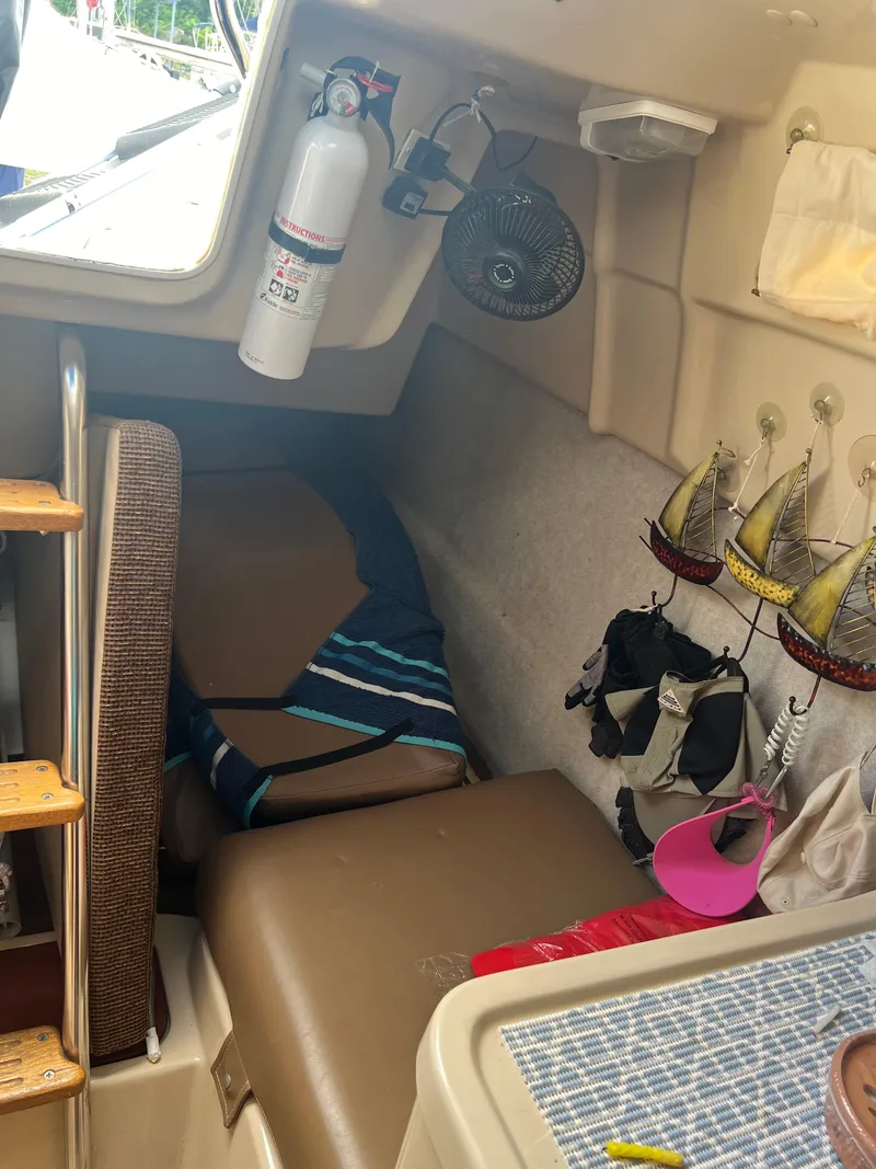 Slide: The Image of Interior cabin of a 2010 MacGregor 26M sailboat with seating and nautical decor. - 5