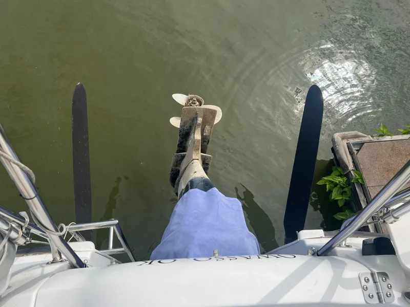 Slide: The Image of MacGregor 26M 2010 boat motor and rudders in water. - 7