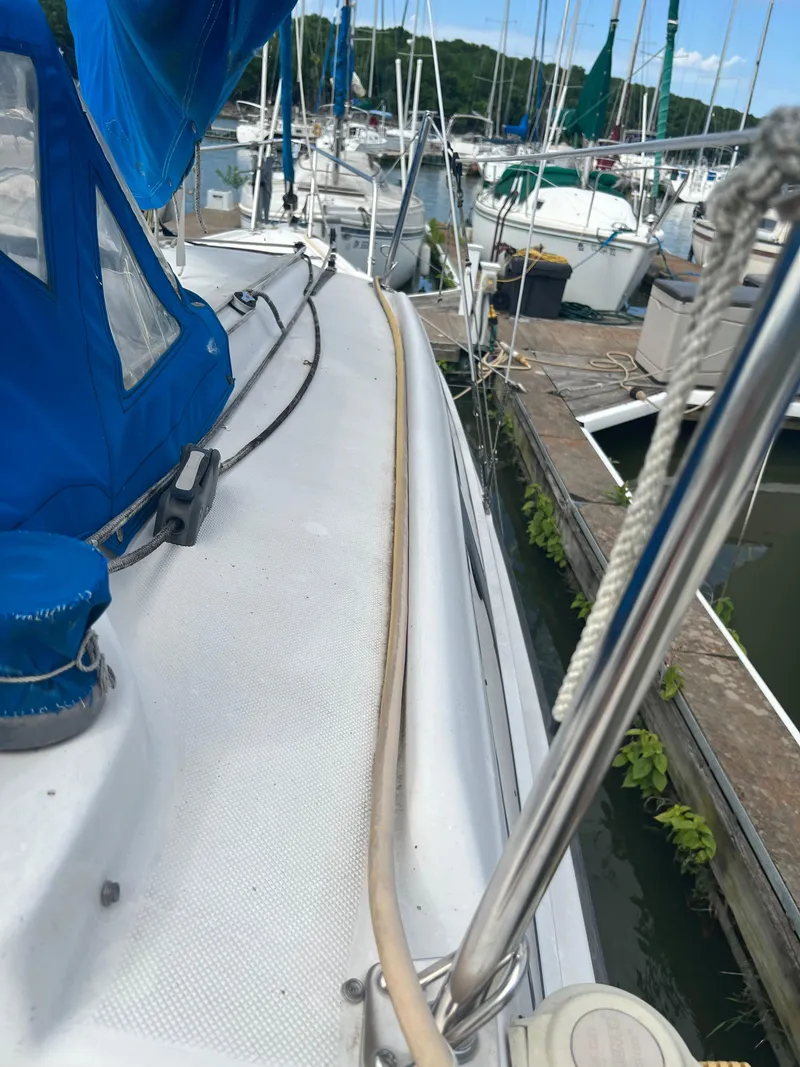 Slide: The Image of 2010 MacGregor 26M sailboat docked at a marina. - 8