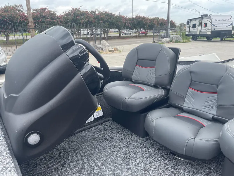 Slide: The Image of 2024 Tracker PT175 boat interior with steering console and two cushioned seats. - 15